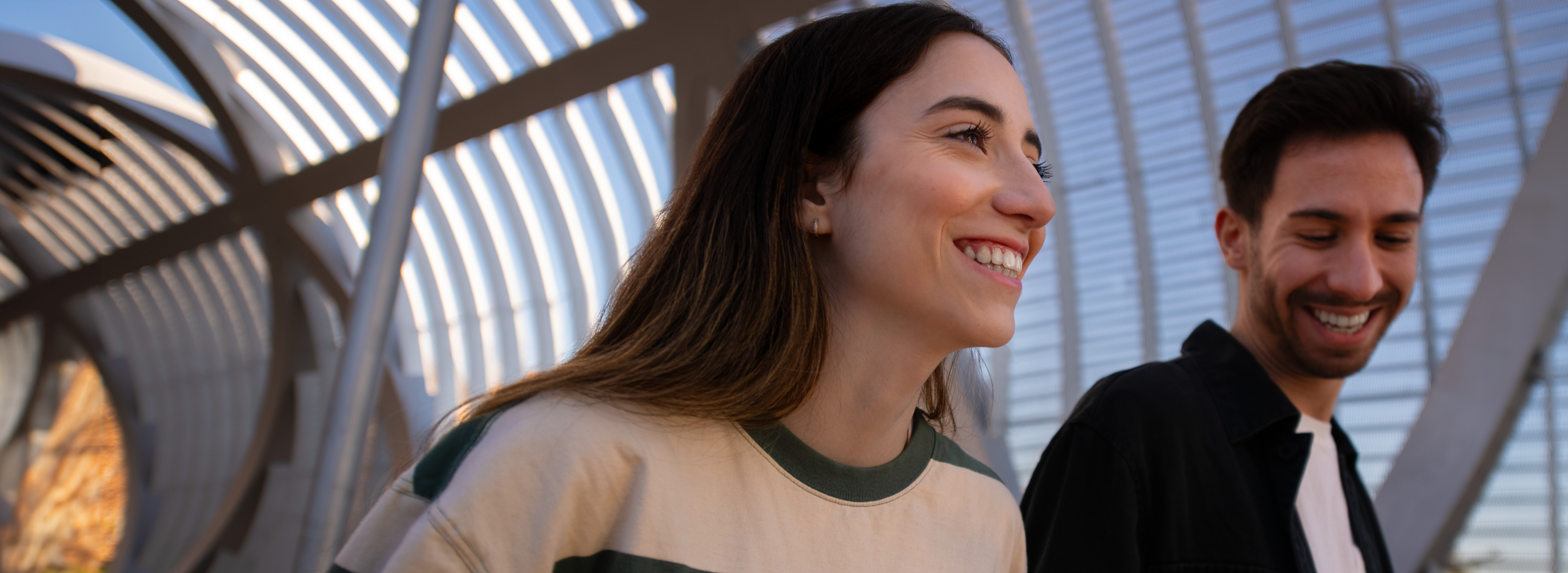 Two people walking together smiling