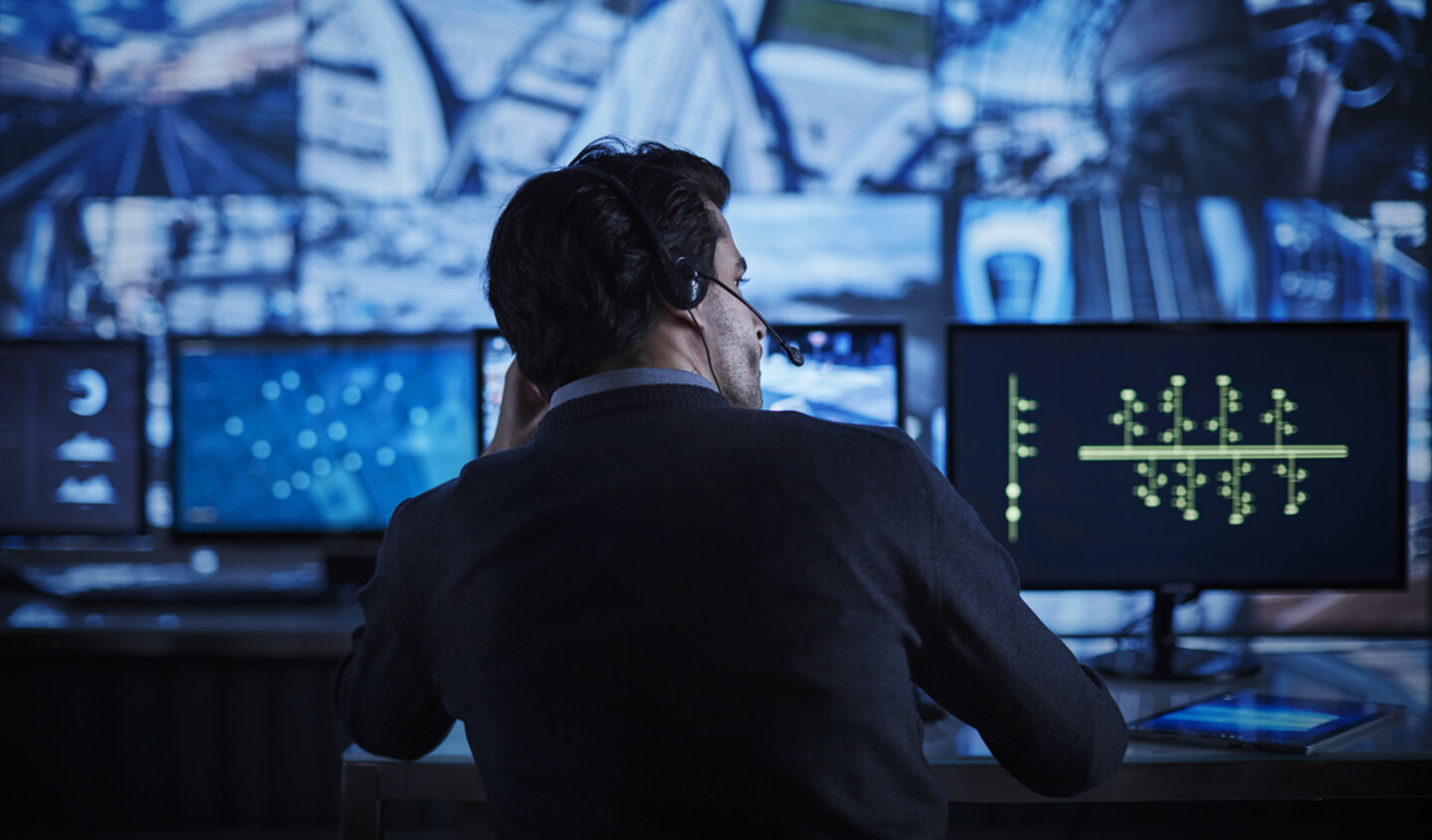 Man working on screens