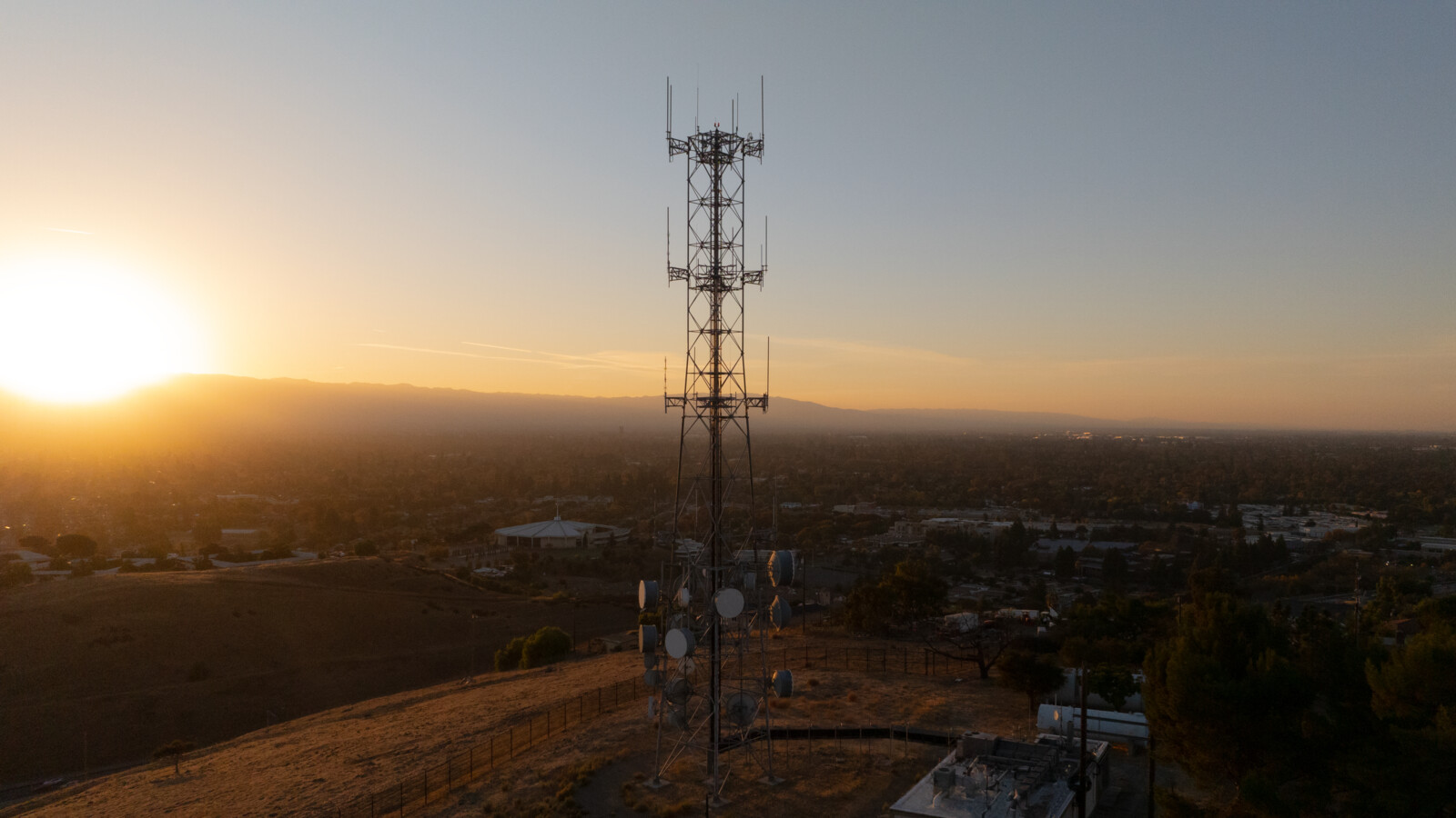 Older antenna site in rural area with sunset