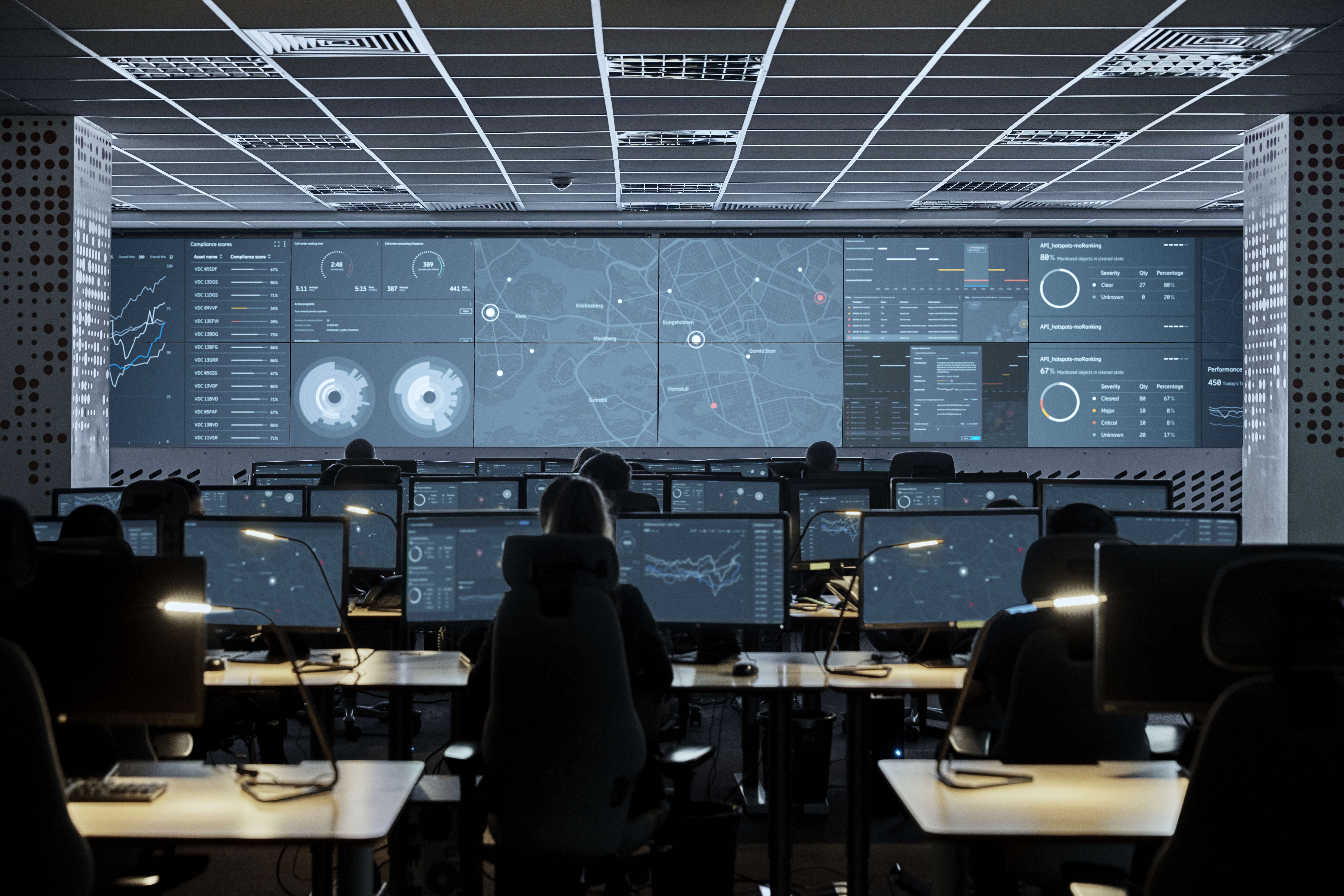 Persons monitoring computer screens.