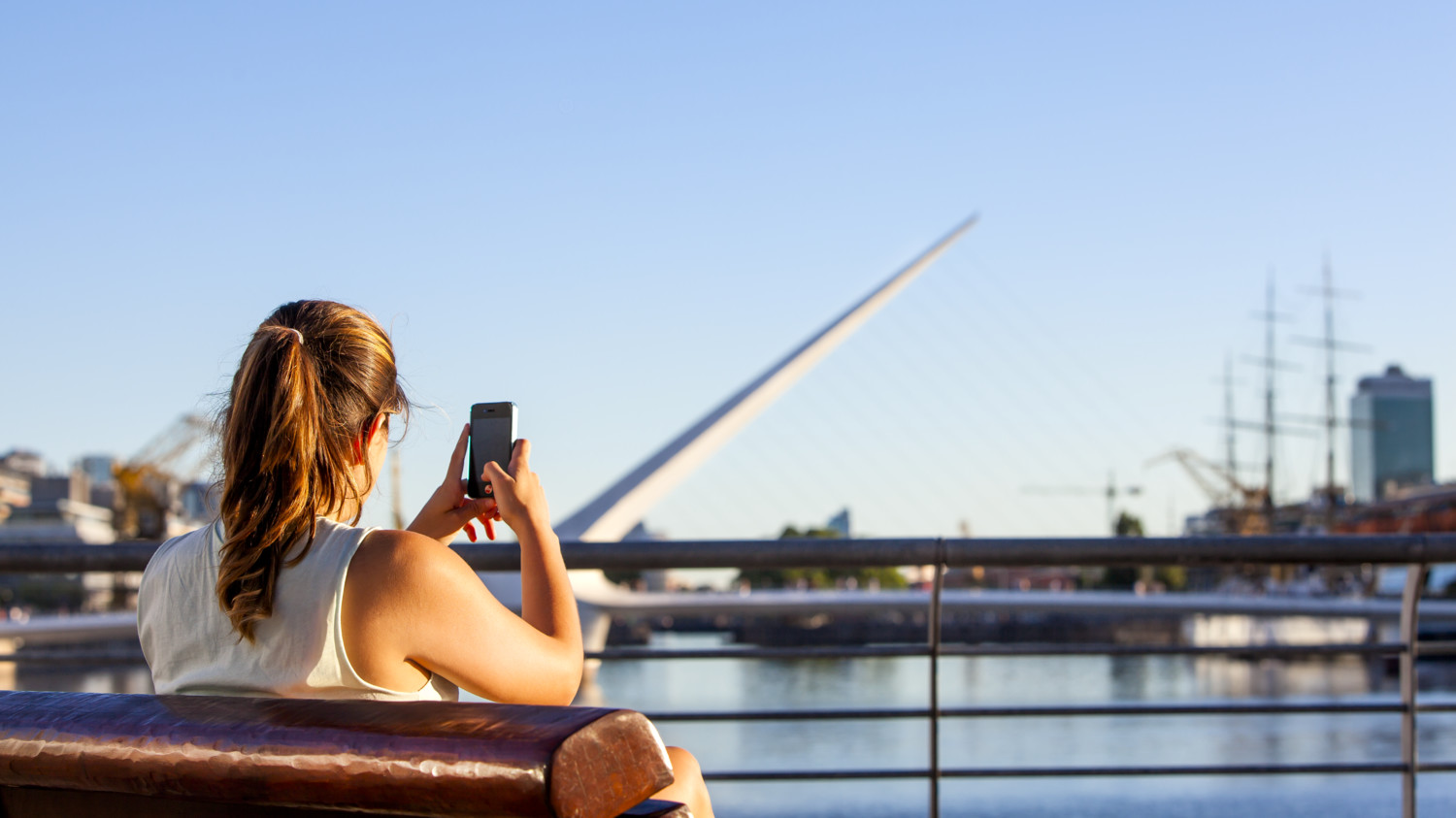 Woman taking photo with mobile phone in Argentina