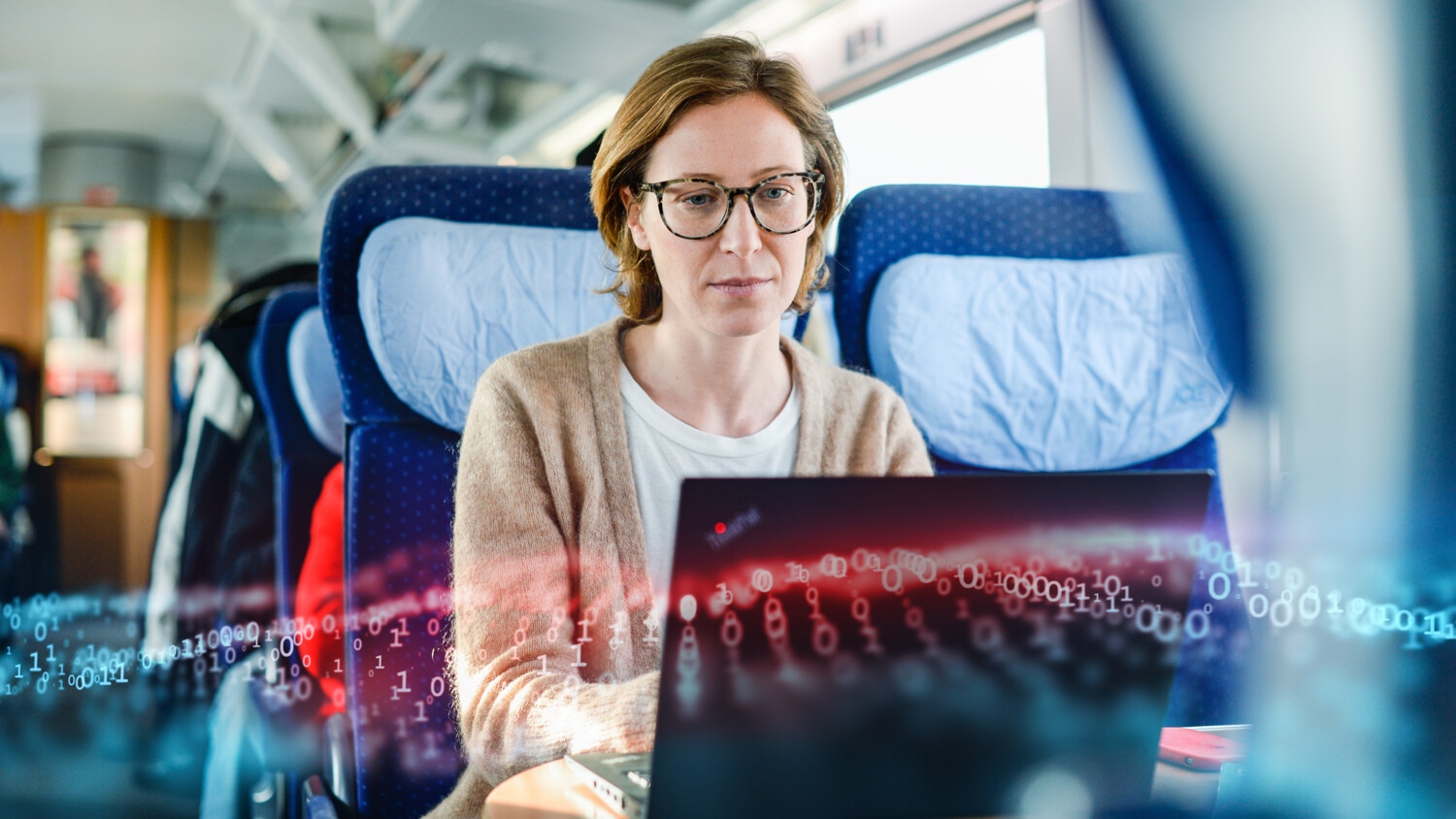 Woman using laptop and 5g on railway train.