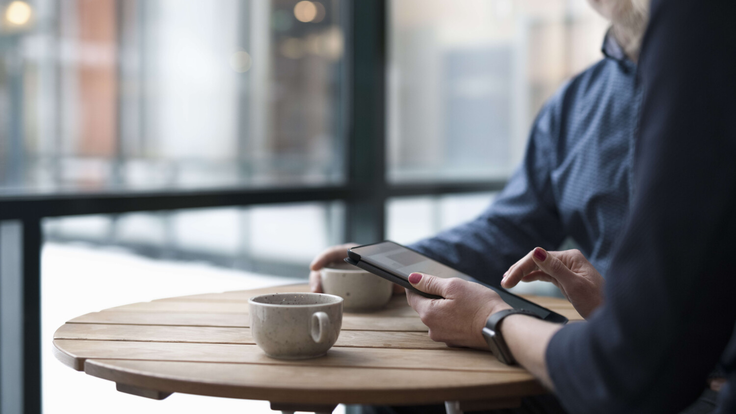 Colleagues discussing over a coffee.