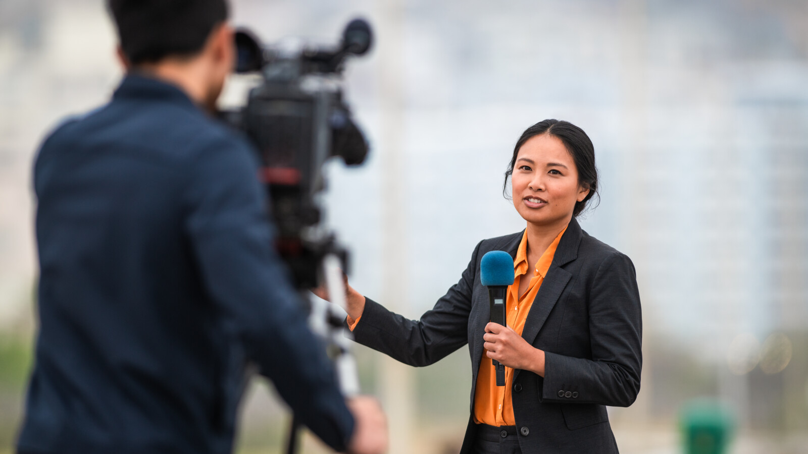 Woman reporter, using remote broadcasting over 5G.