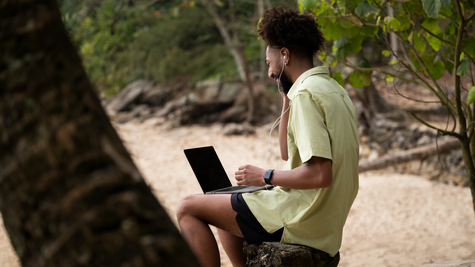 Man working remote on beach