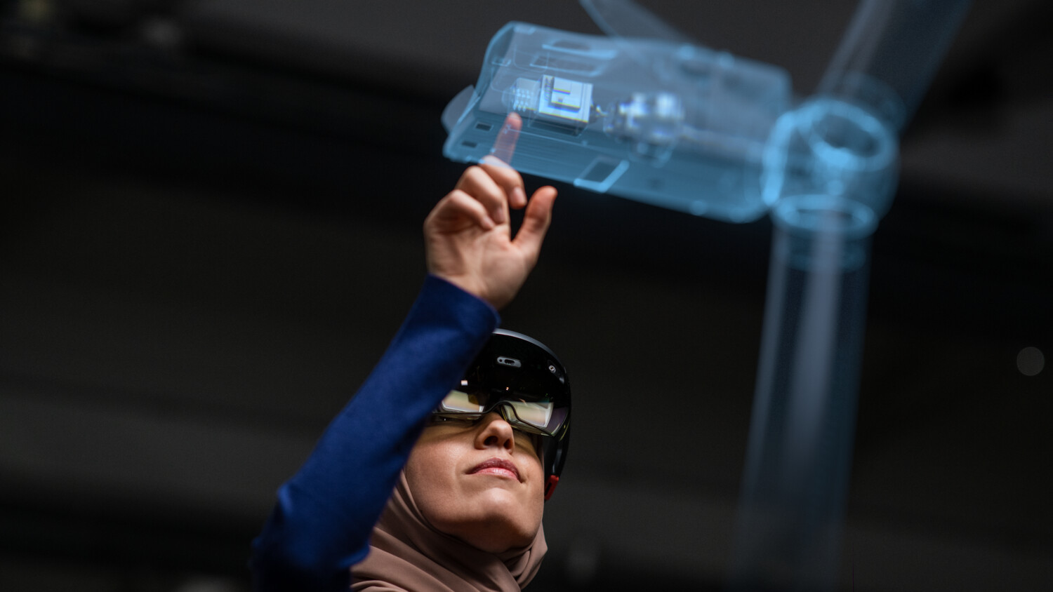 A female IT Professional working with AR glasses and holograms