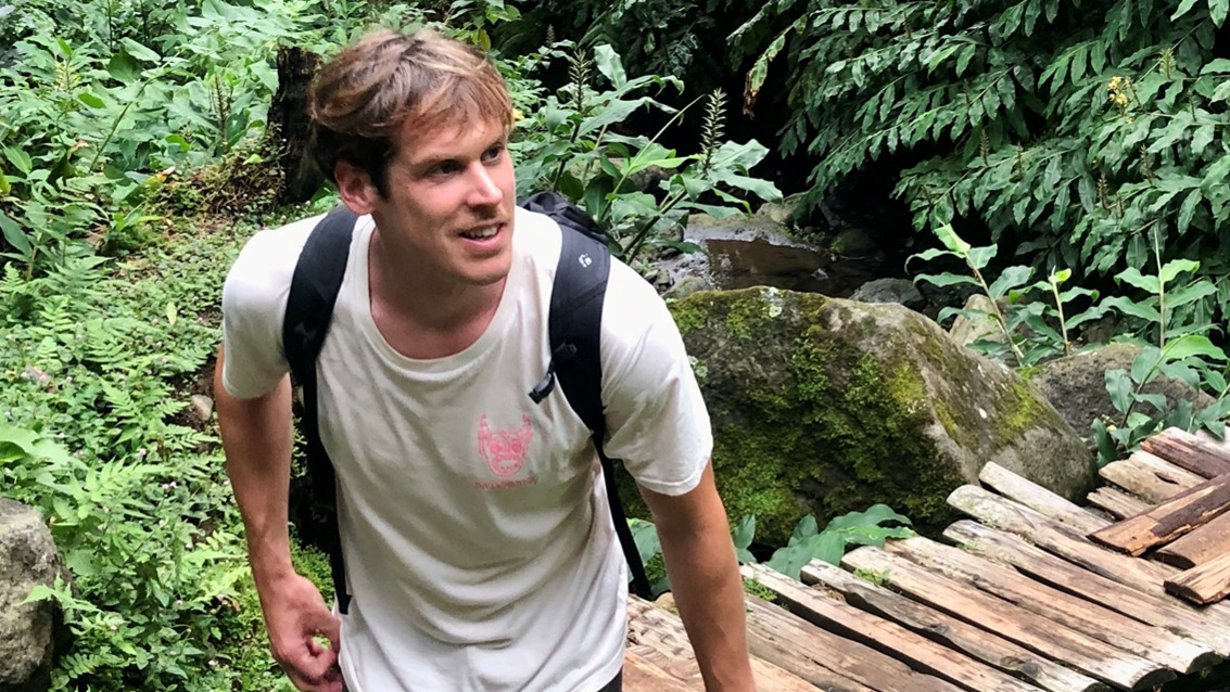 Dominik walking in a forest.