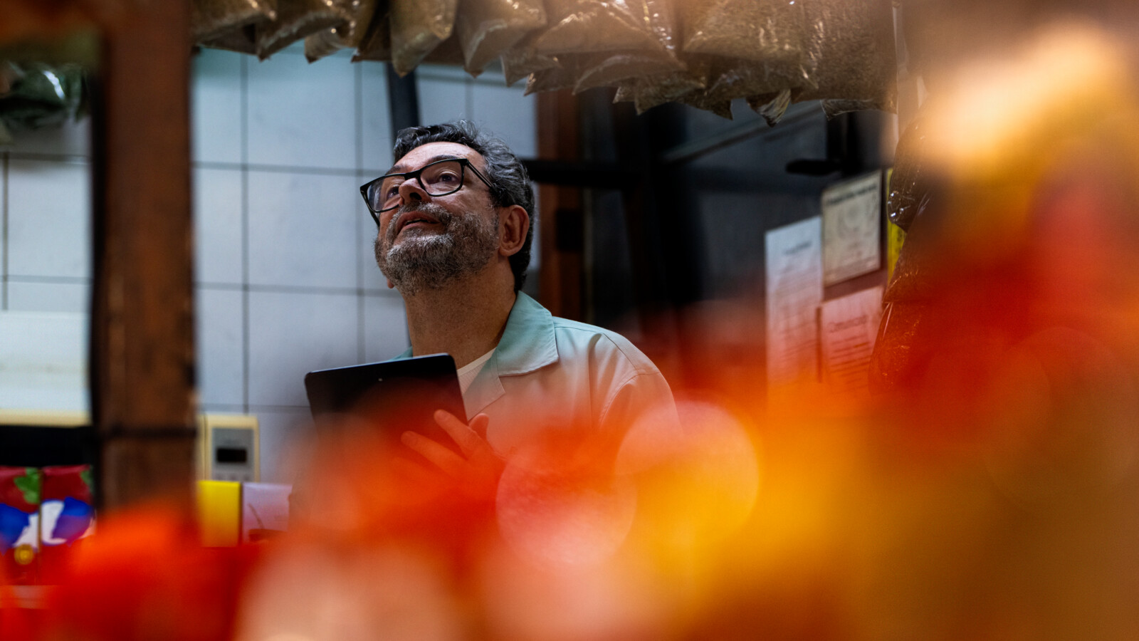 Man on a production site using smart-glasses with tablet device