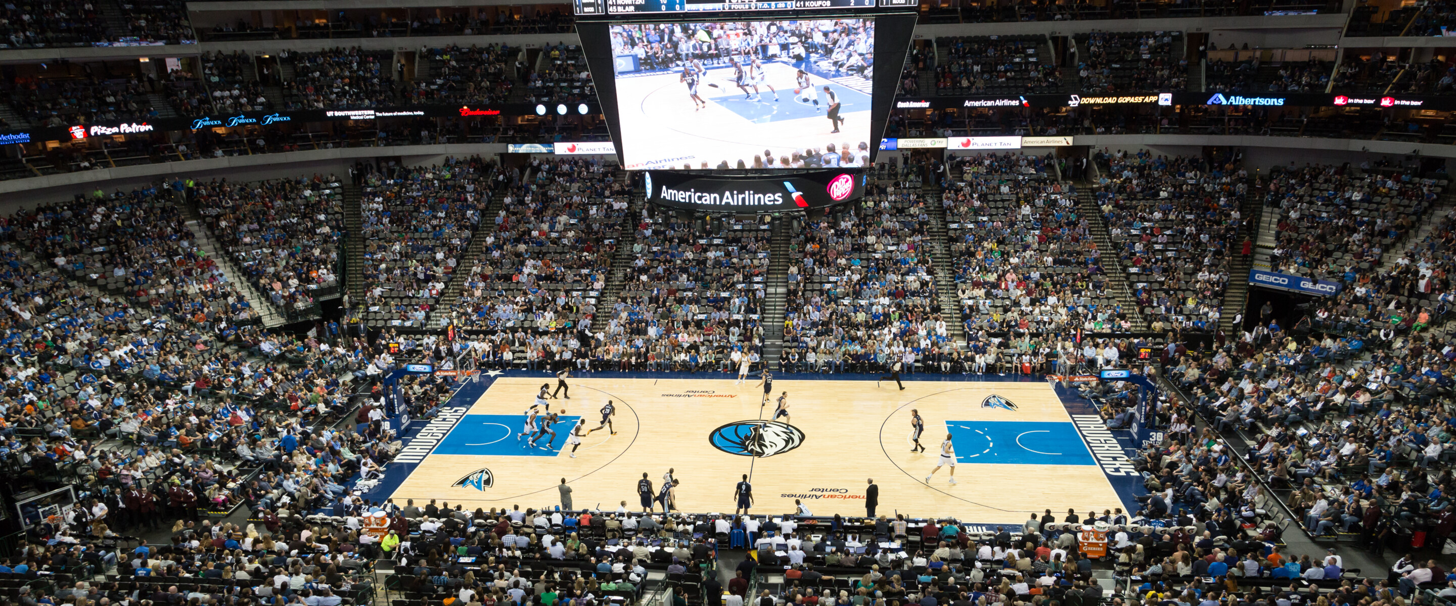 Wide shot of a professional basketball stadium during a game.