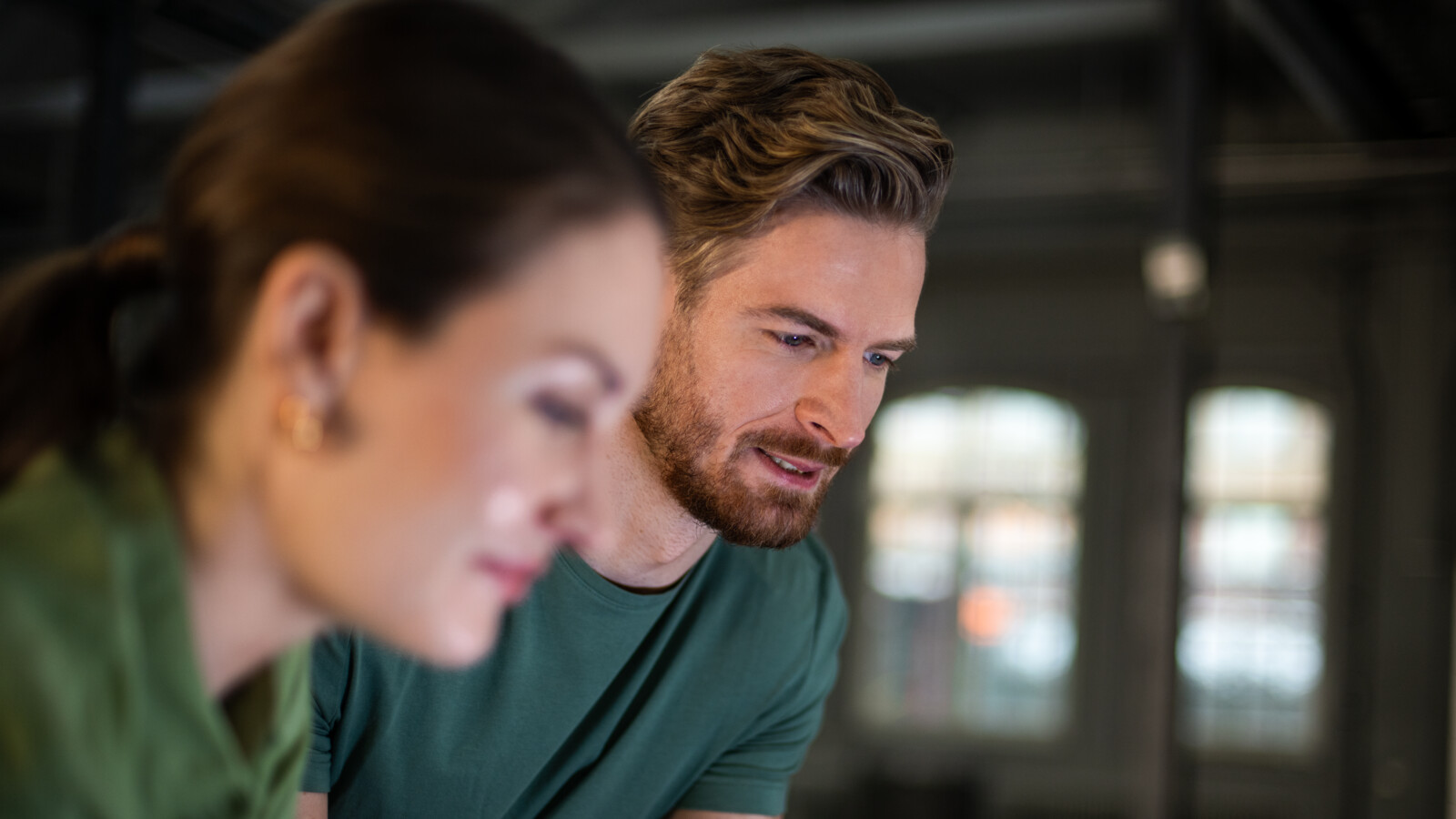 A man and a woman looking at a screen.