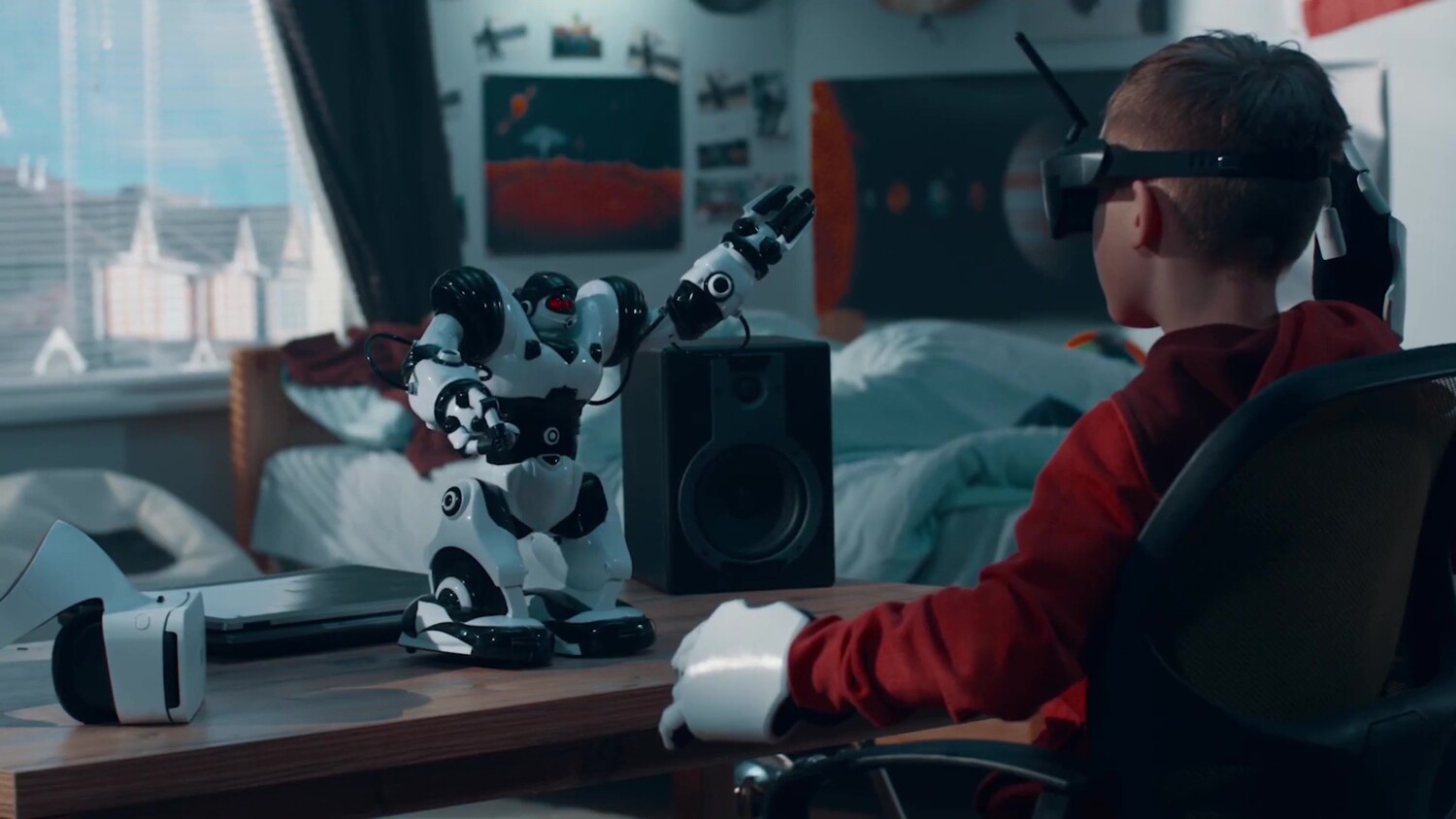 Child playing with toy robot