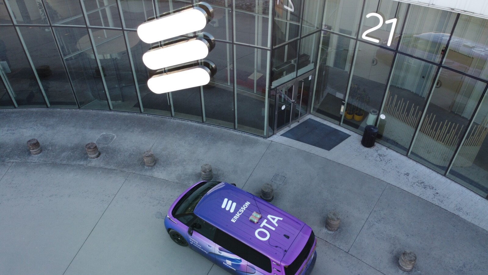 Purple car with Ericsson logo and name on the roof used for OTA or over-the-air demo in Kista, Sweden