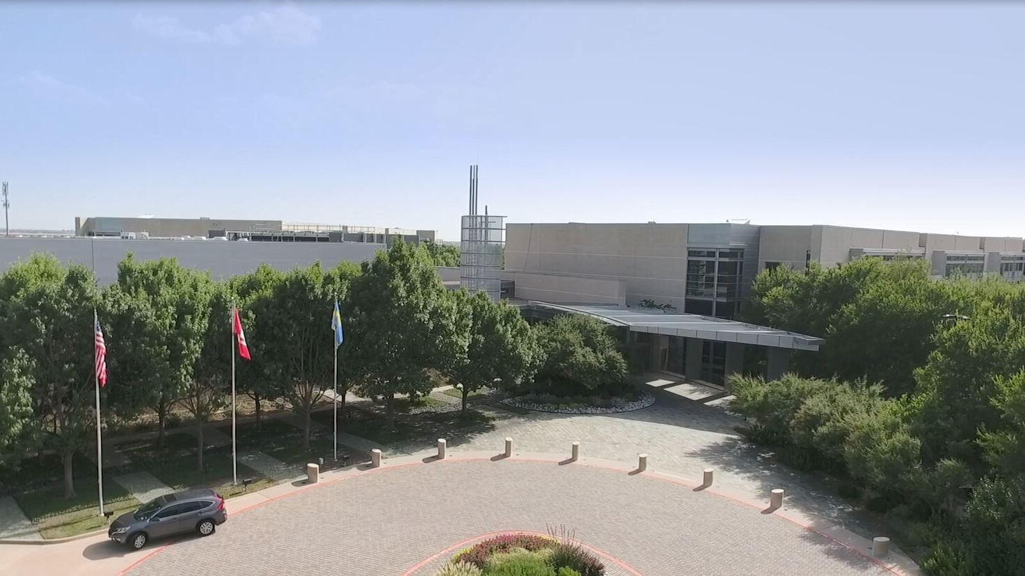 建築群內有旗幟、樹木和環形車道。