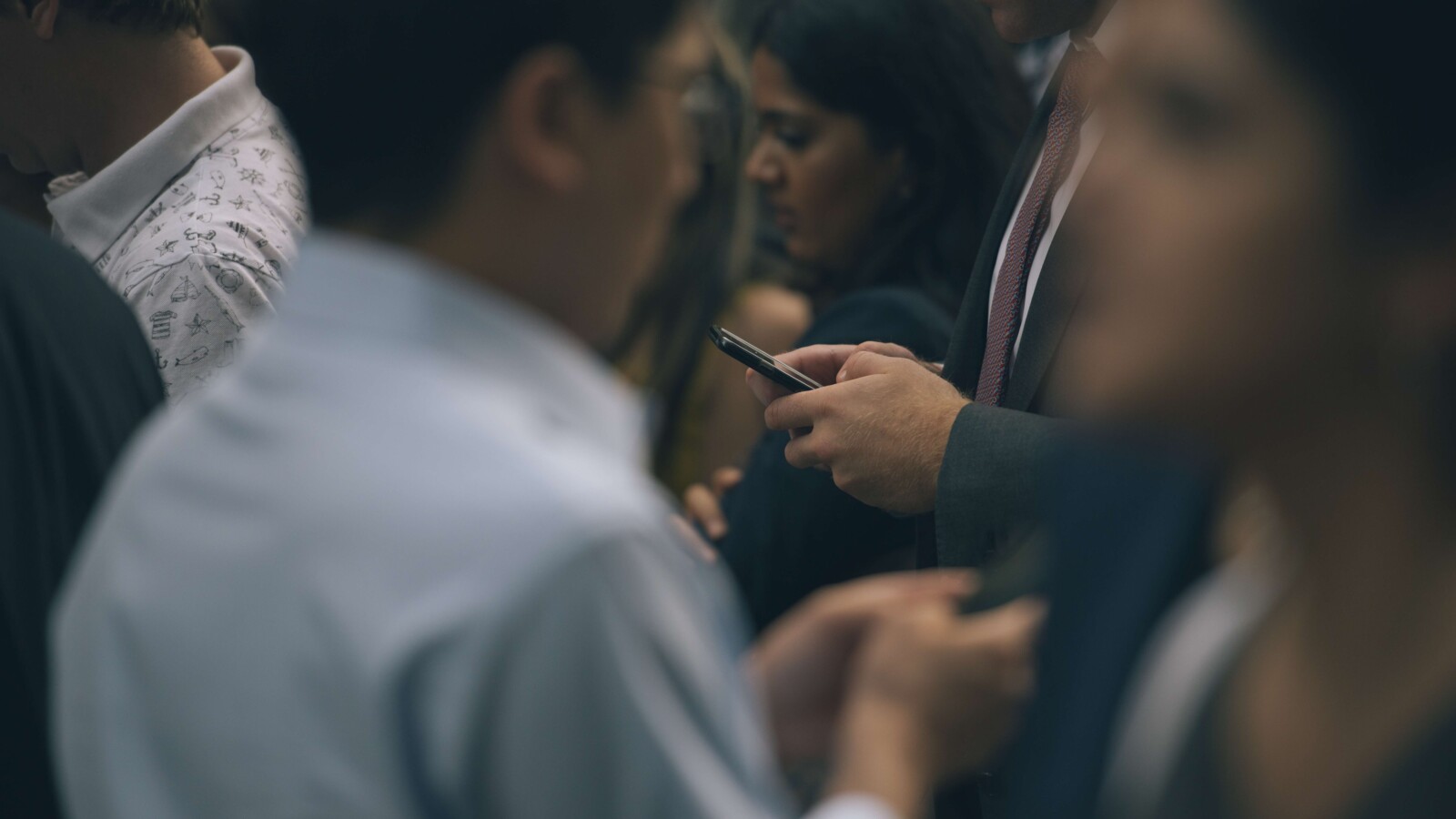group of people holding mobiles