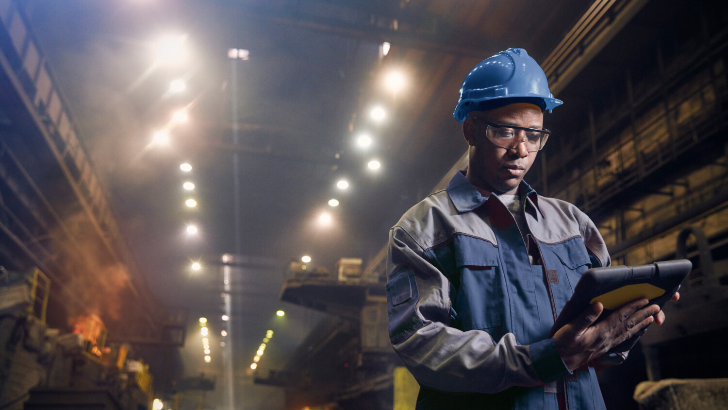 A worker with helmet and a tablet.