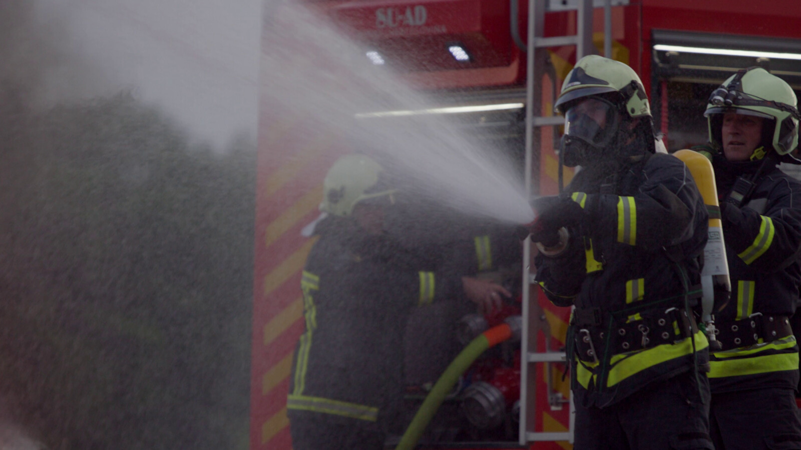 Firefighters spraying water during a fire.
