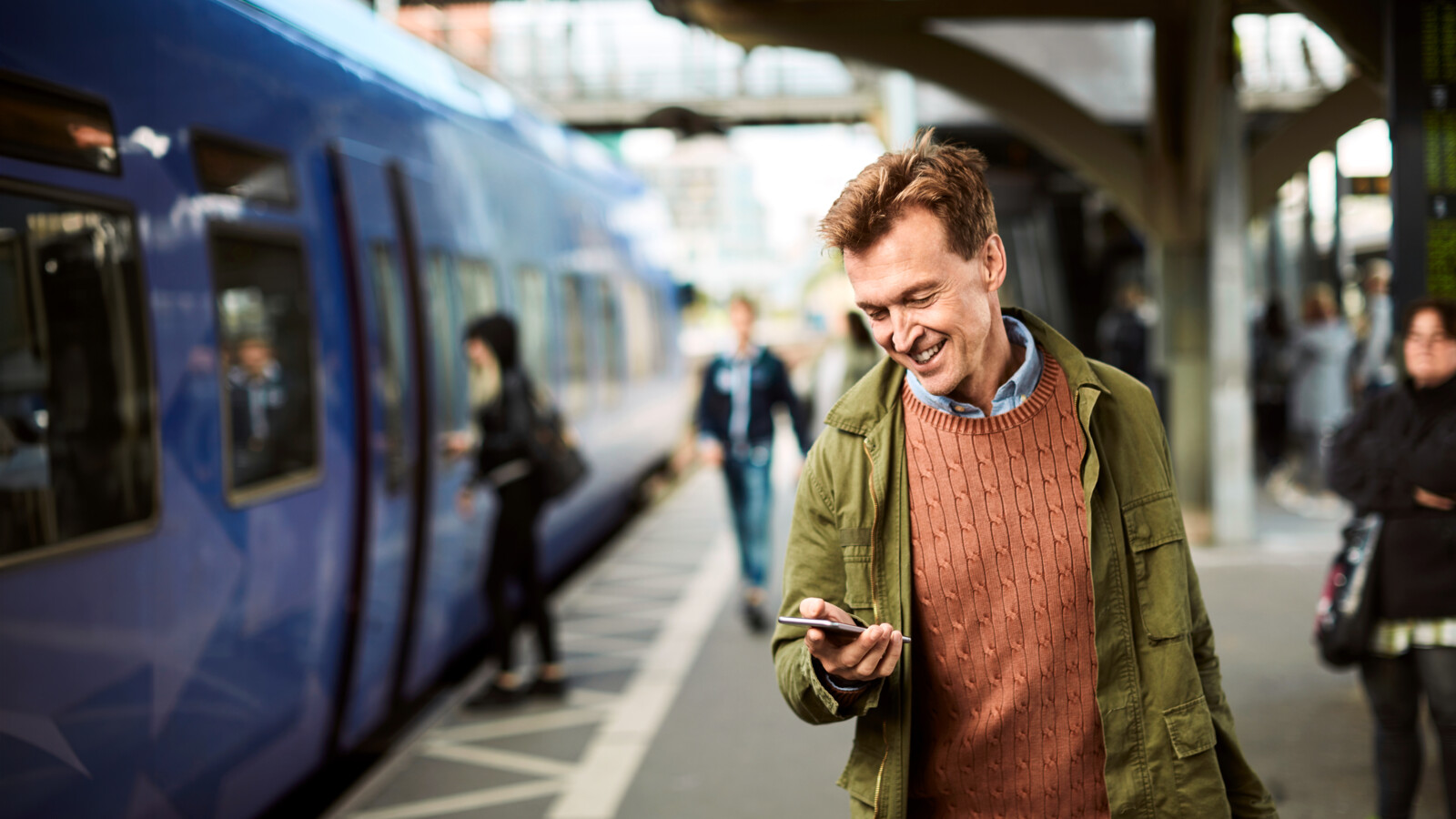 Man using his smartphone at the train station