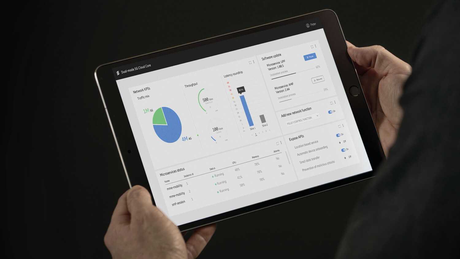 Hands holding a tablet.