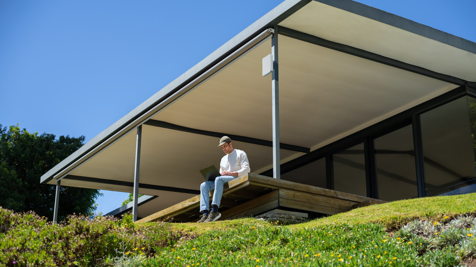 Man remotely working outdoors with a FWA Router.