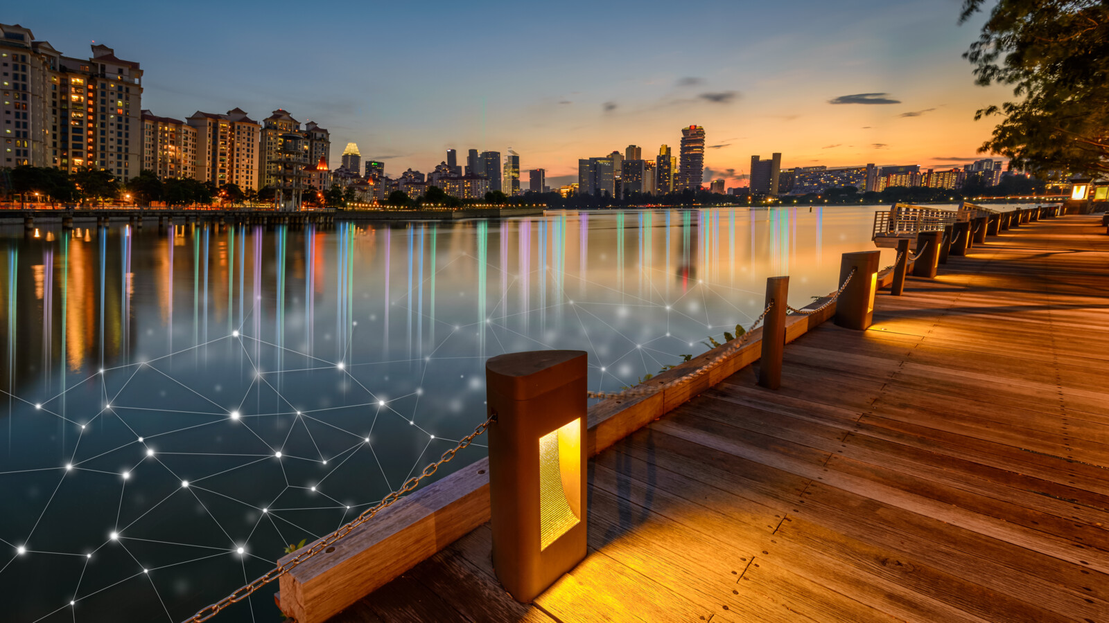 City skyline at dusk with graphic overlay over the water, illustrating tech network.