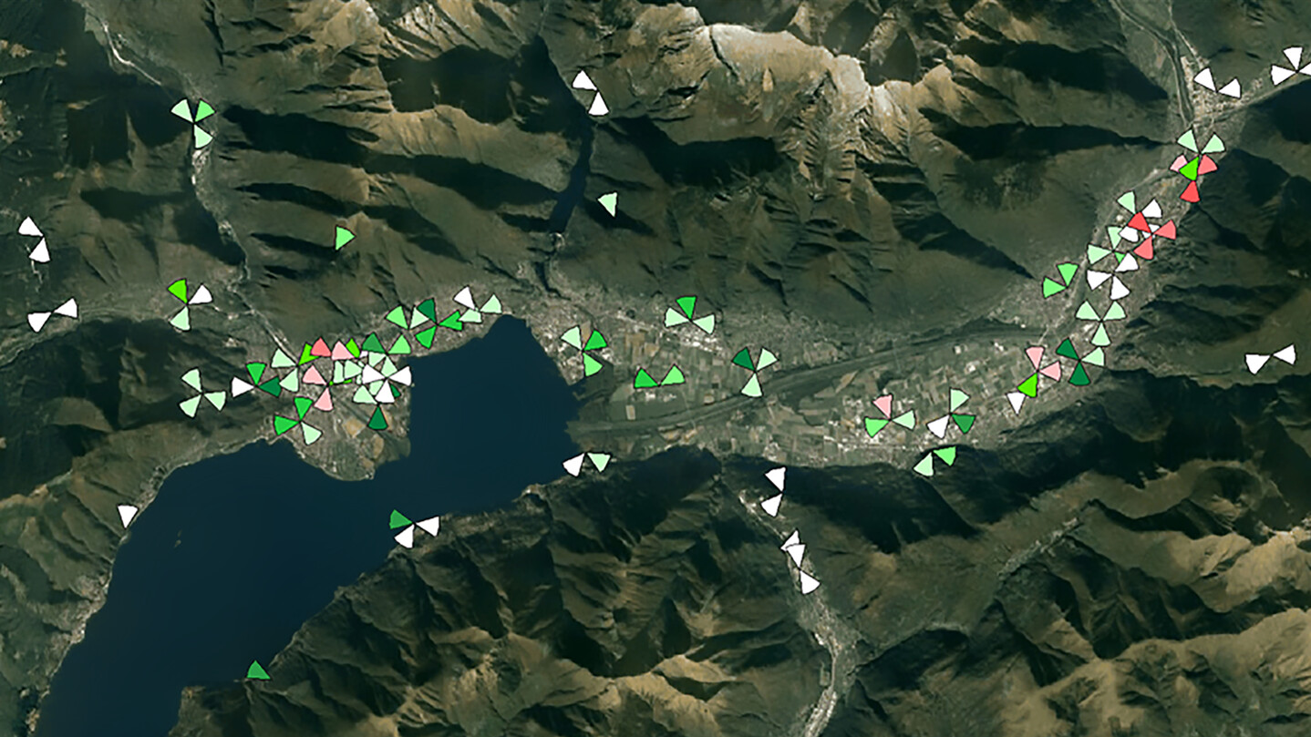 Satellite view of mountains with colored data markers.