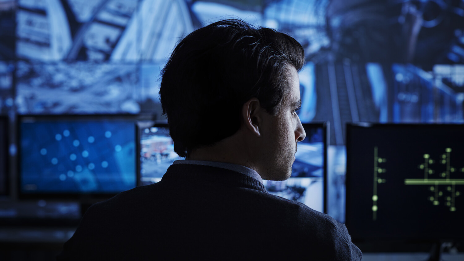 Person monitoring computer screens.