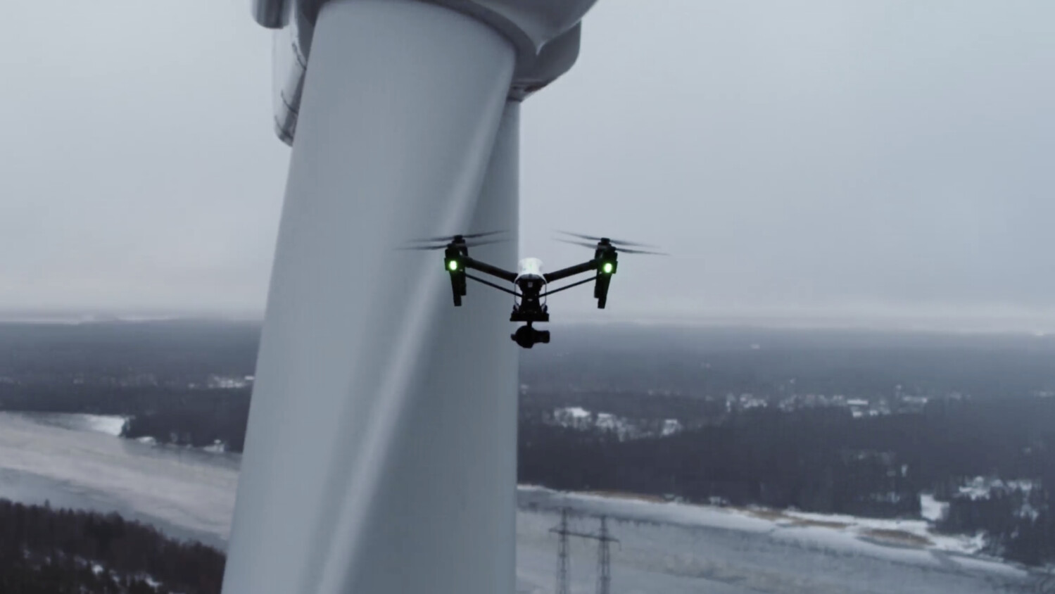 Drone inspecting wind turbine.