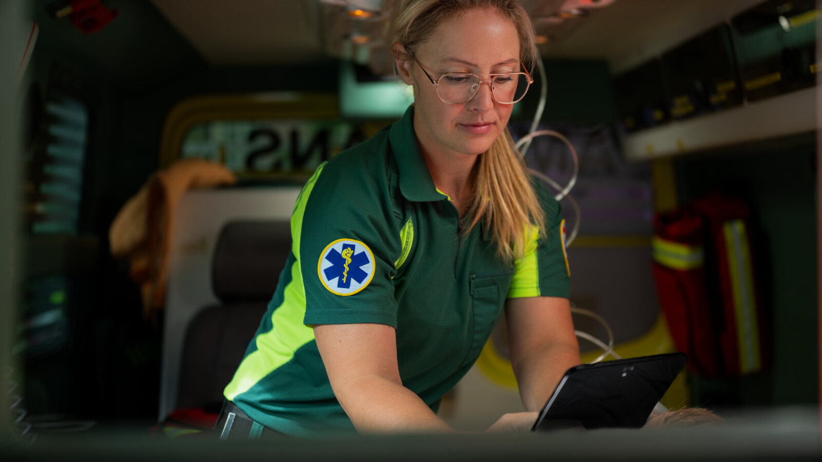 Rescuer inside the ambulance checking and sending data.