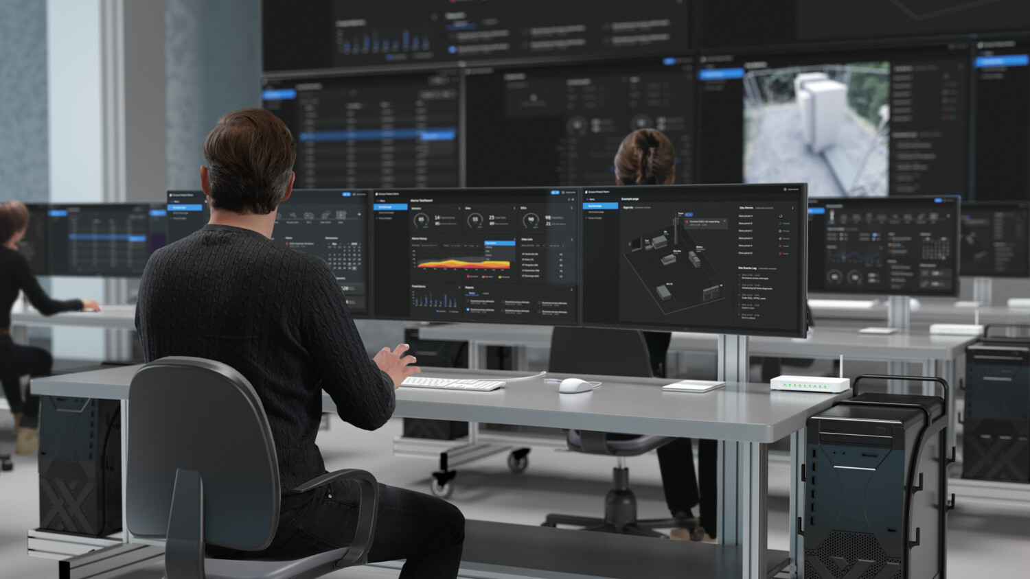 Persons monitoring computer screens.