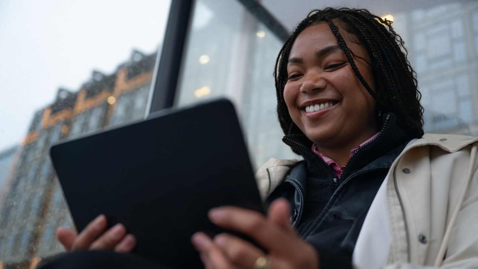 Woman smiling at tablet