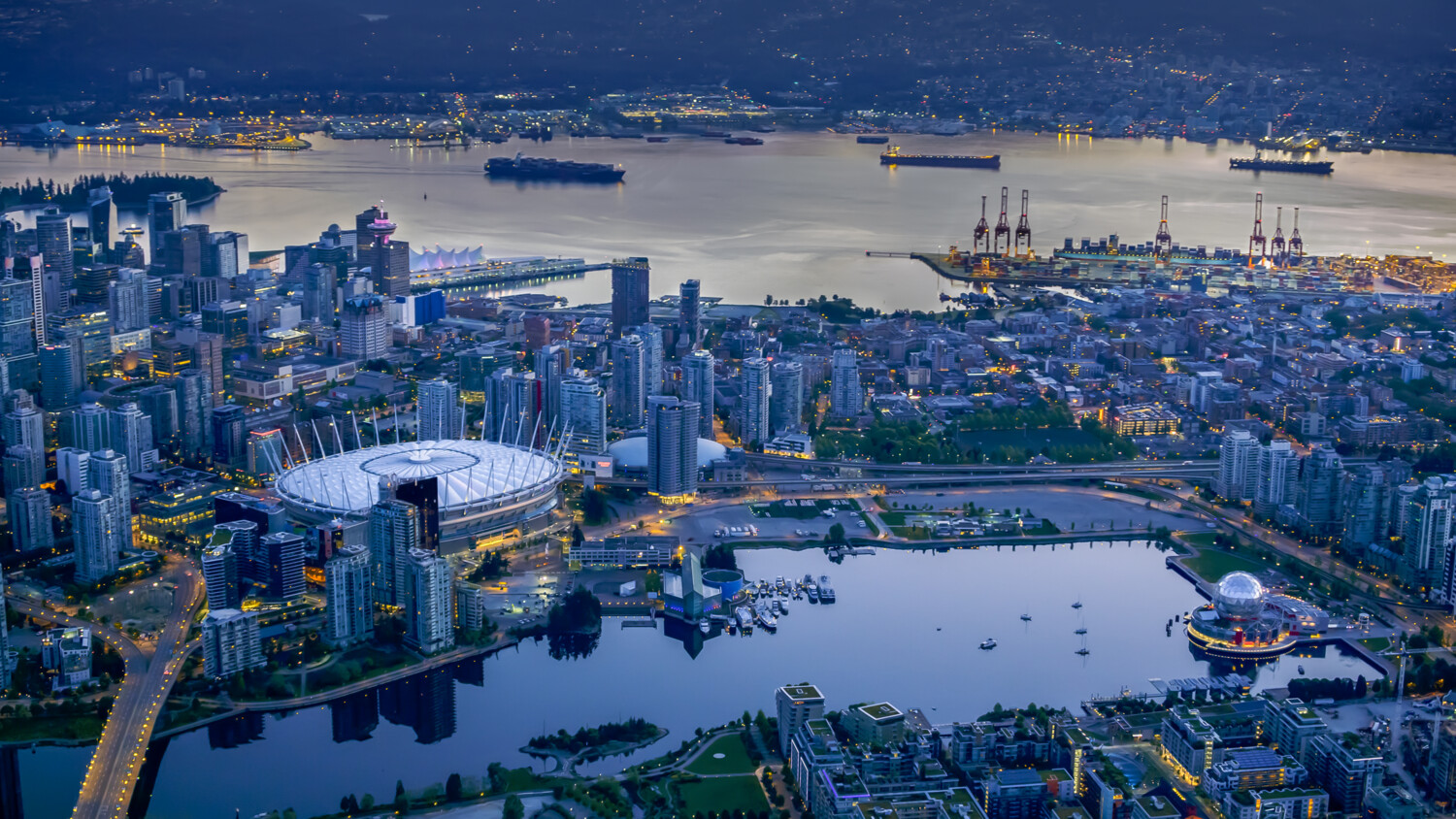 City in the dawn with stadium, harbor, and water areas