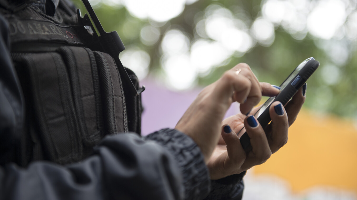 Hands holding a mobile phone.