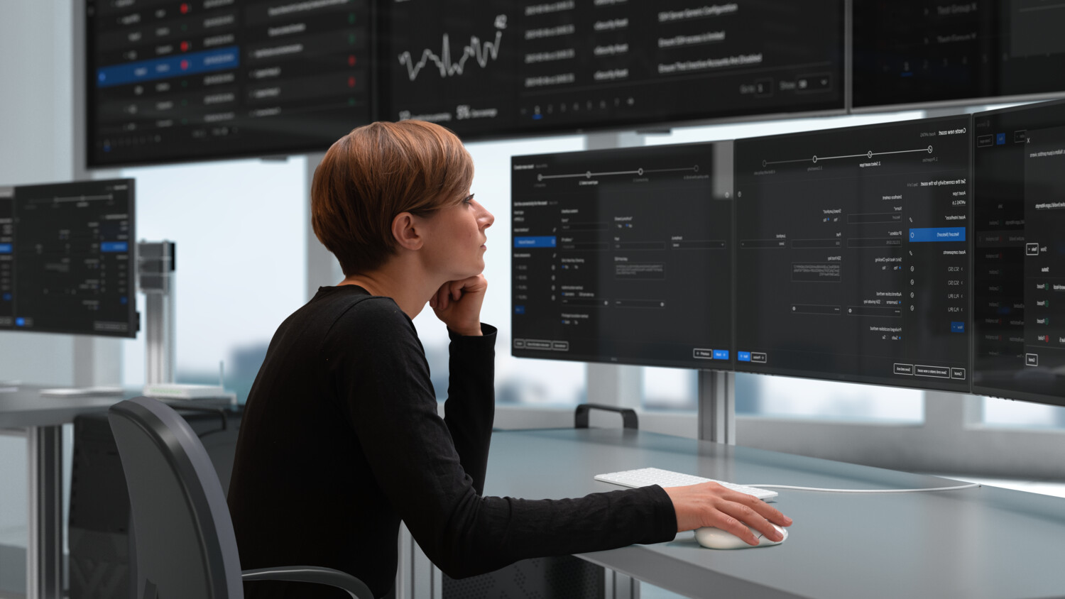 Security manager monitoring computer screens.