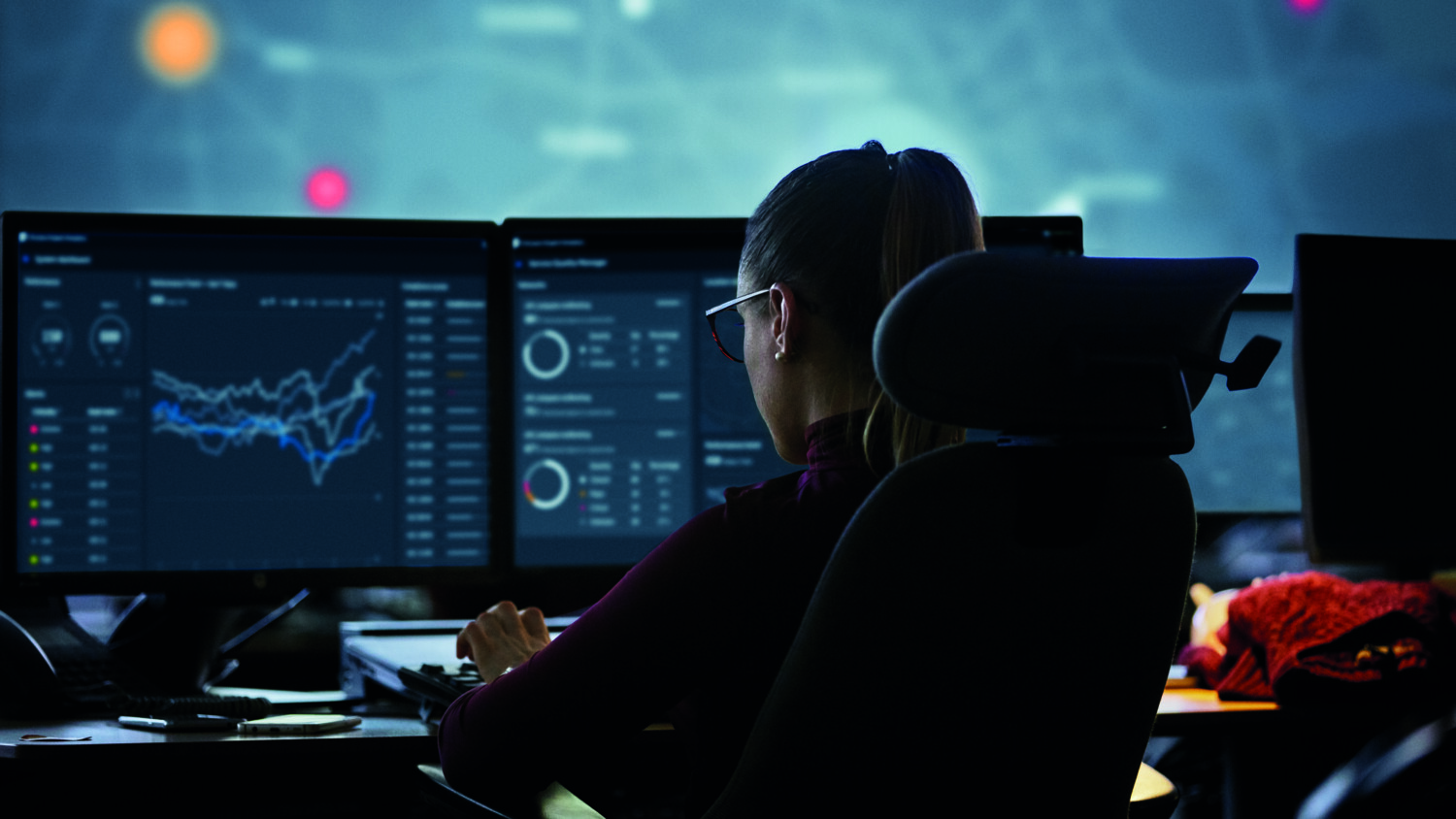 Woman infront of screens with interfaces visible
