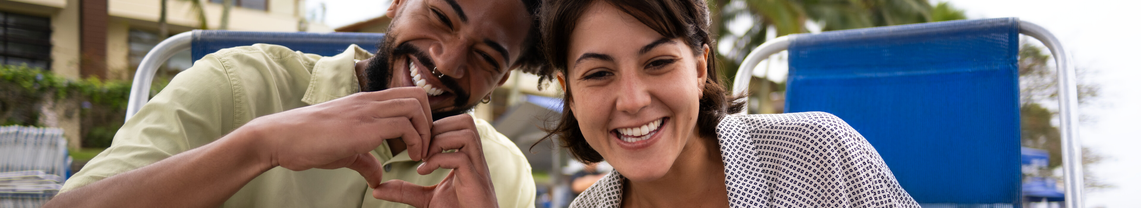 Man and woman smiling and looking at computer.