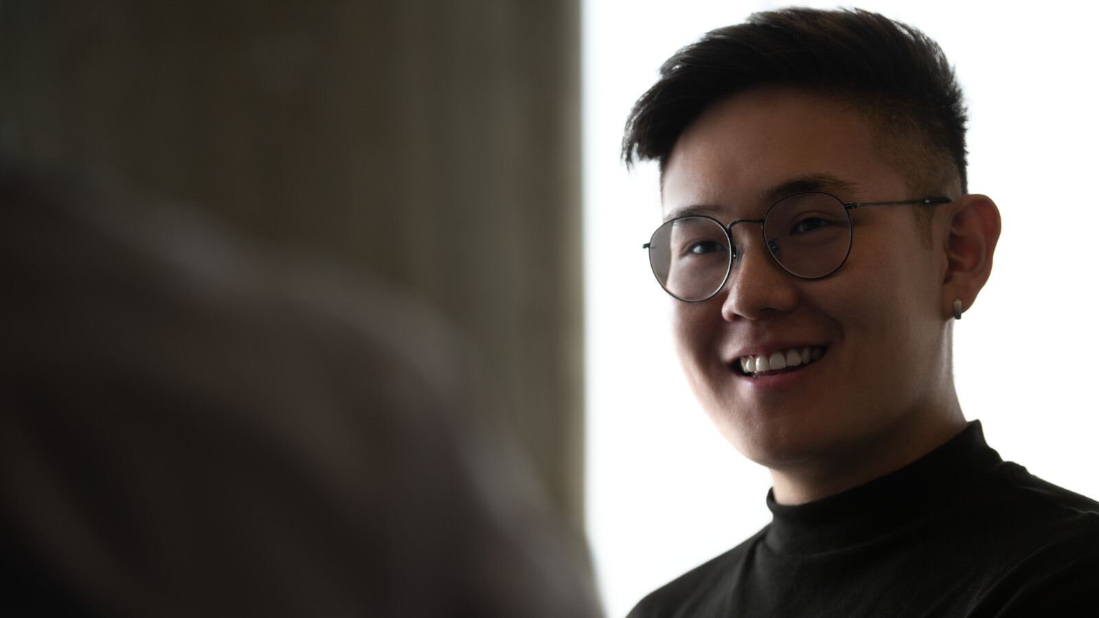 Man smiling at coworker or customer.