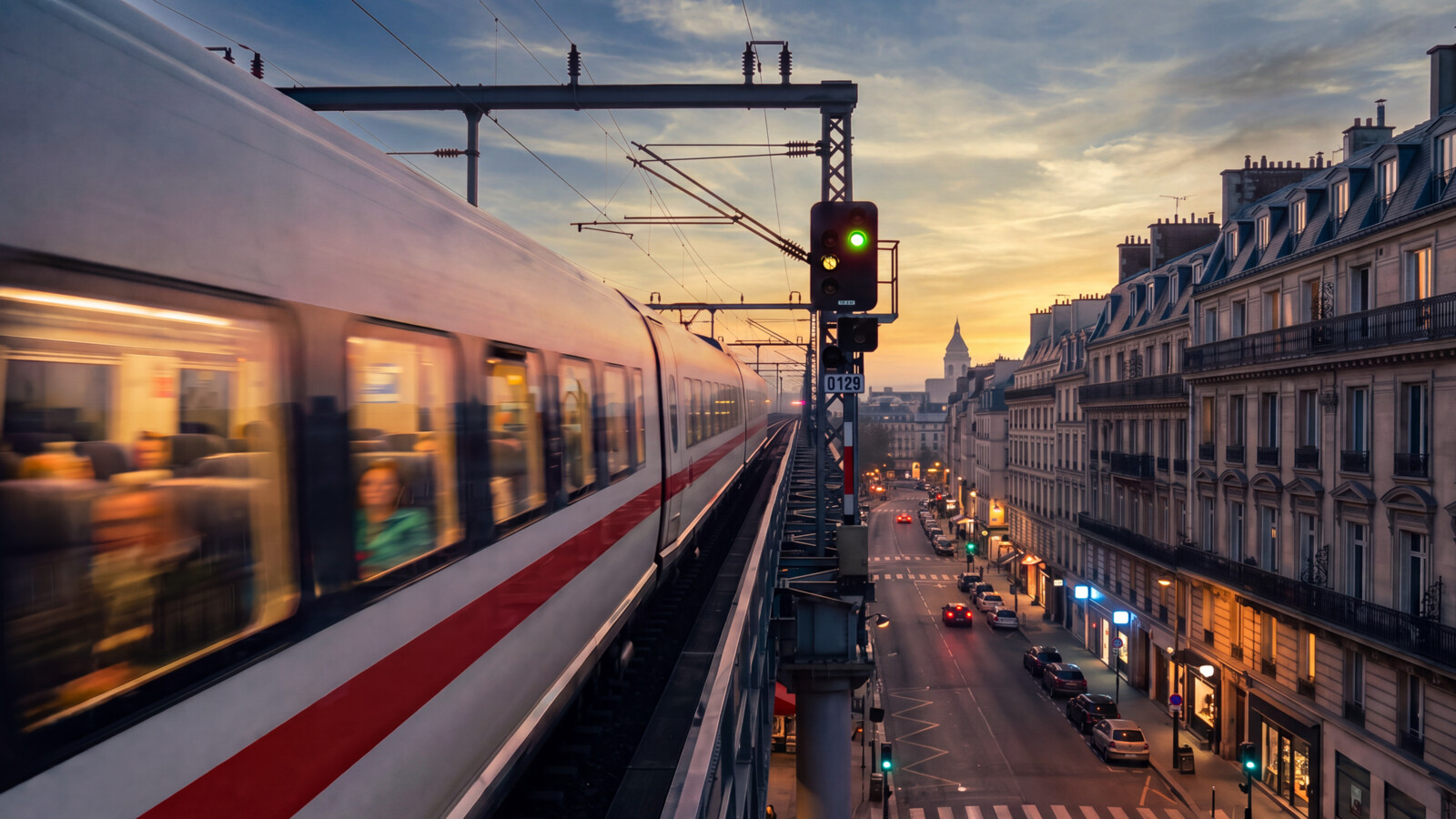 AI-generated image of a train in an aboveground urban setting at sunset.