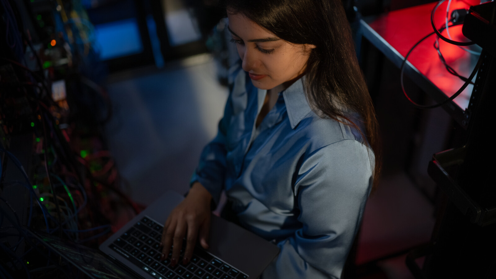  Woman checking computer in server room
