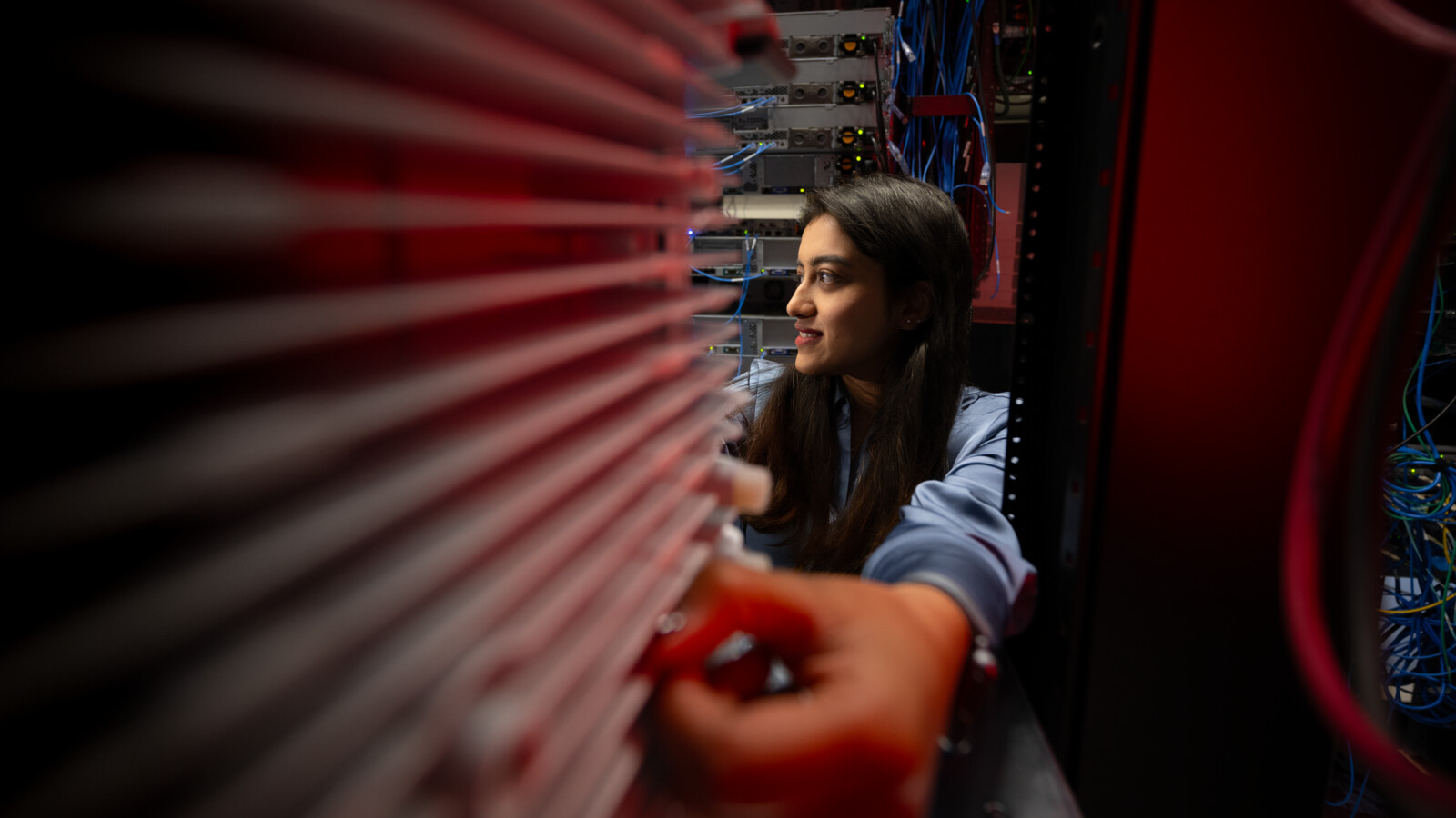 Woman checking rack in server room