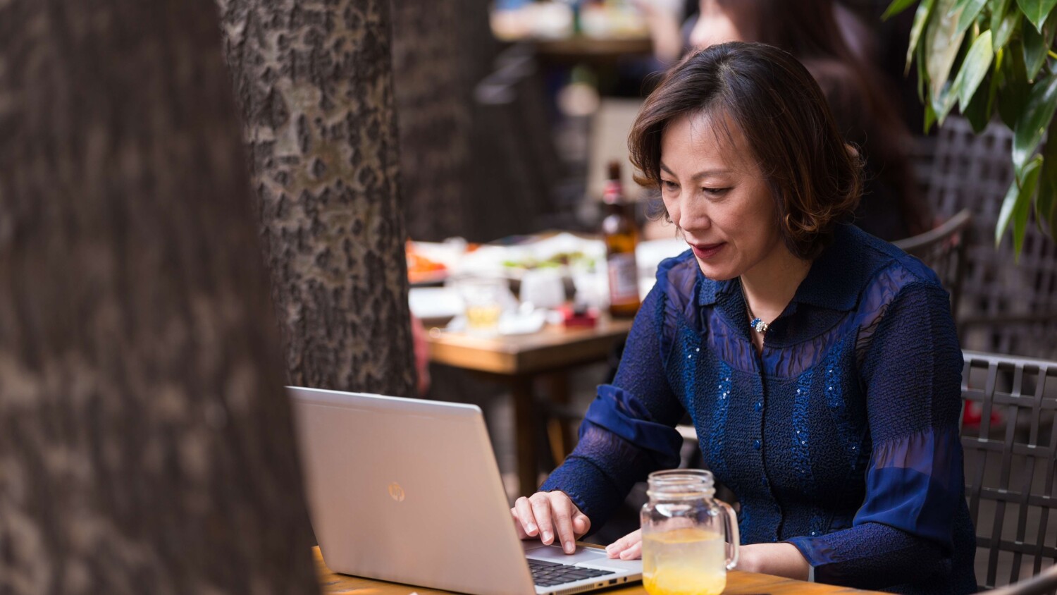 woman working outside with laptop