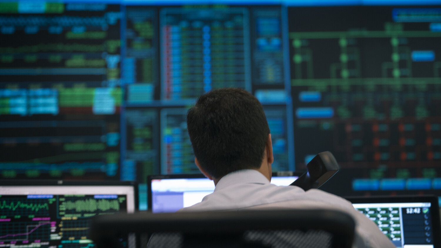 Man working at a control center.