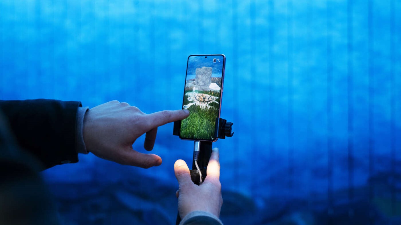 A phone with a turtle in AR on the screen