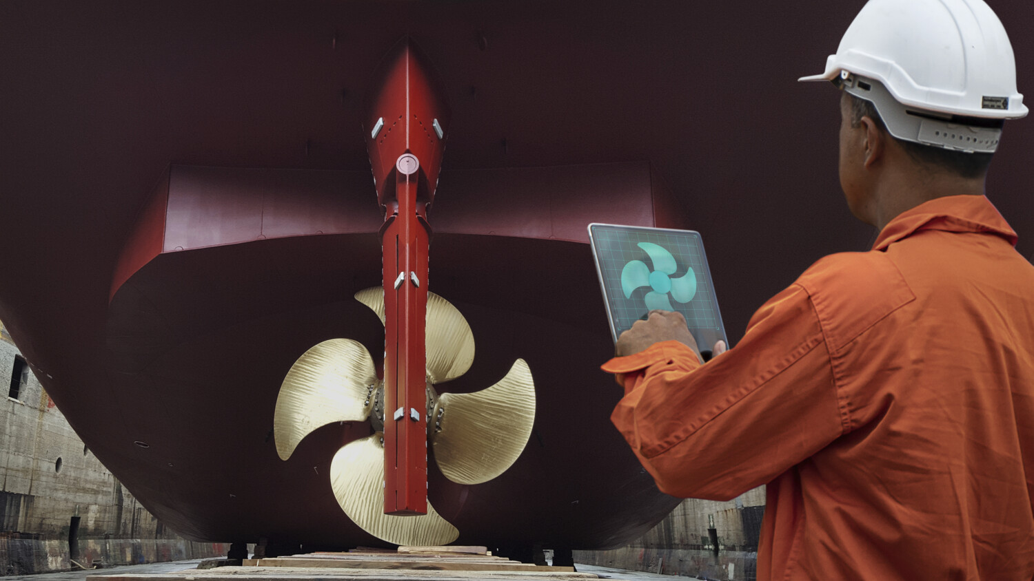 Engineer in a dock monitoring via digital twin of ship propeller.