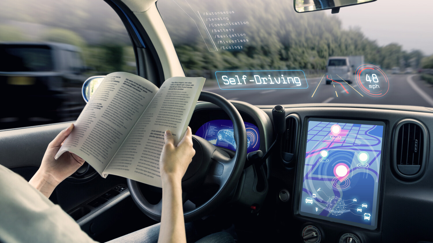 Person reading a book in a self driving car.