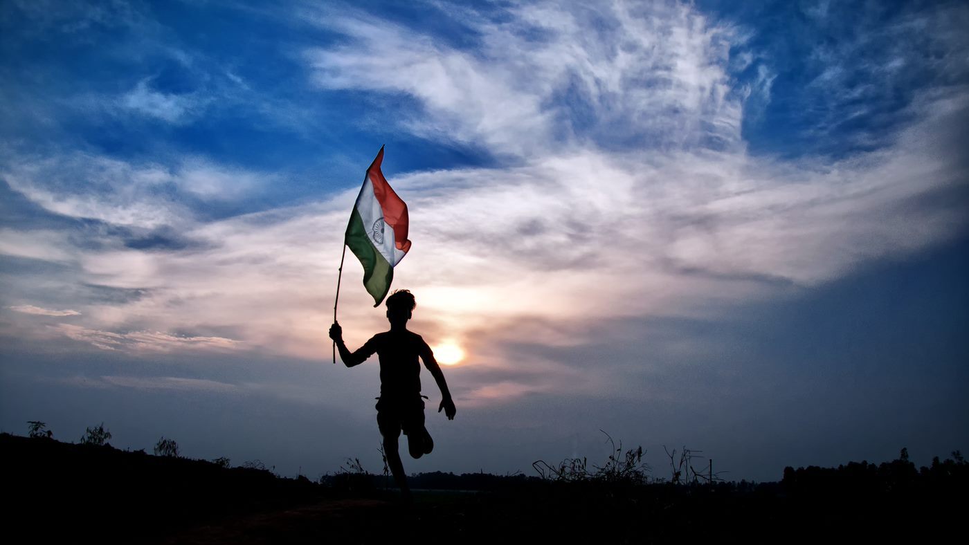 Silhouette of a person holding Indian flag