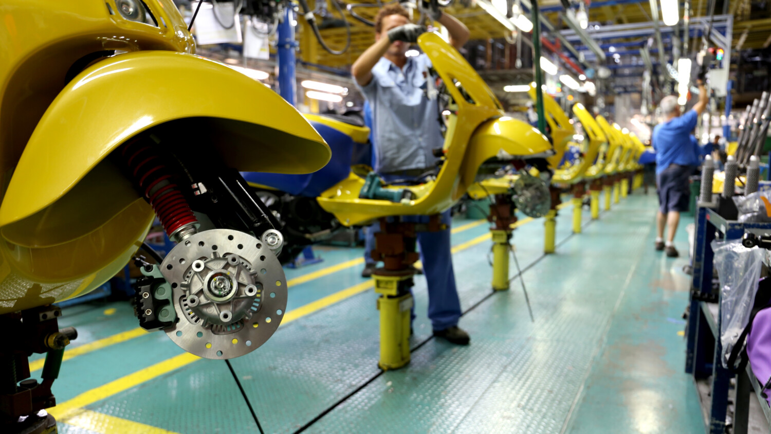 Men working in a Piaggio factory in Tuscany