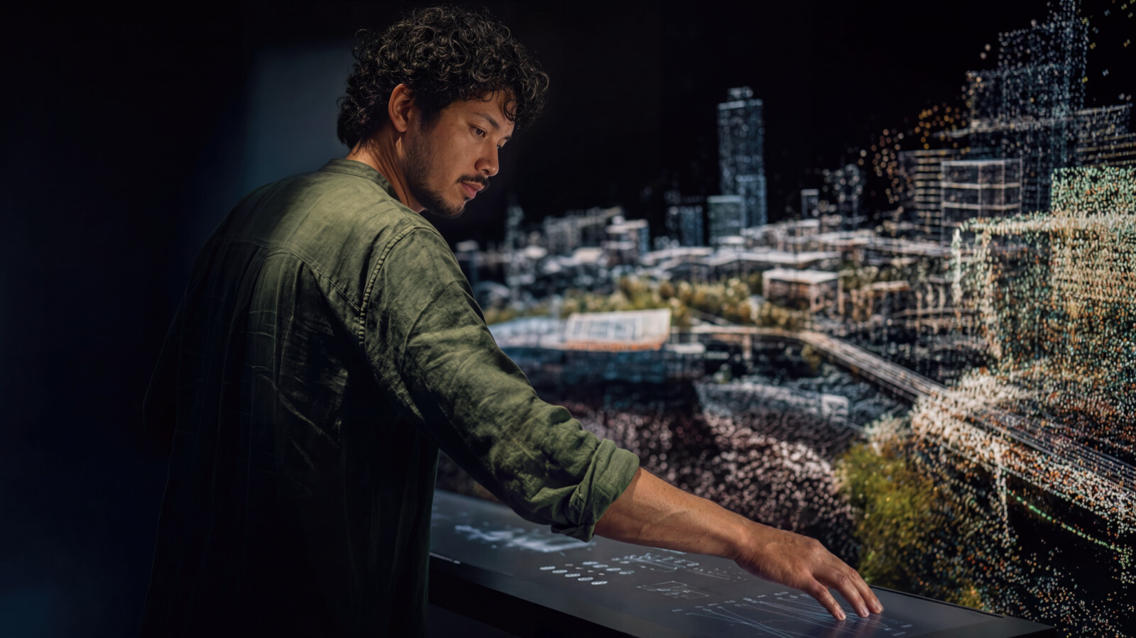A man looking at and interacting with a massive digital twin