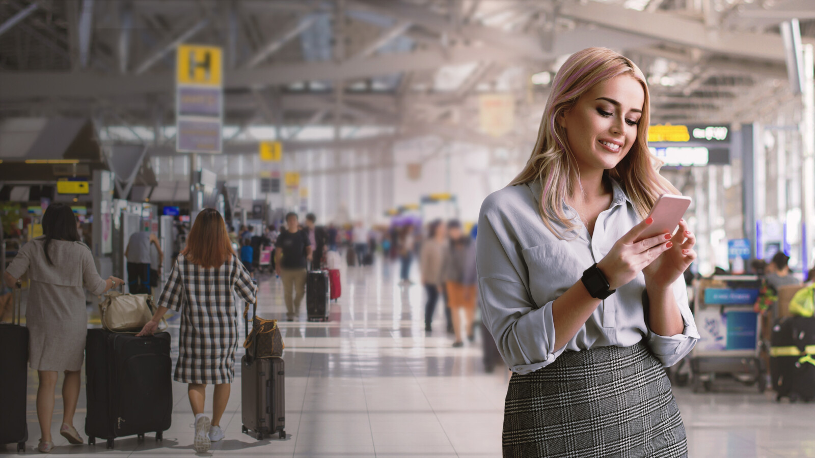 Woman looking at her phone at the airport