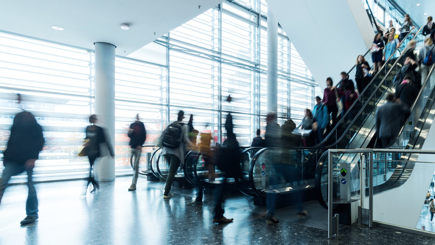 People in a airport escalator.