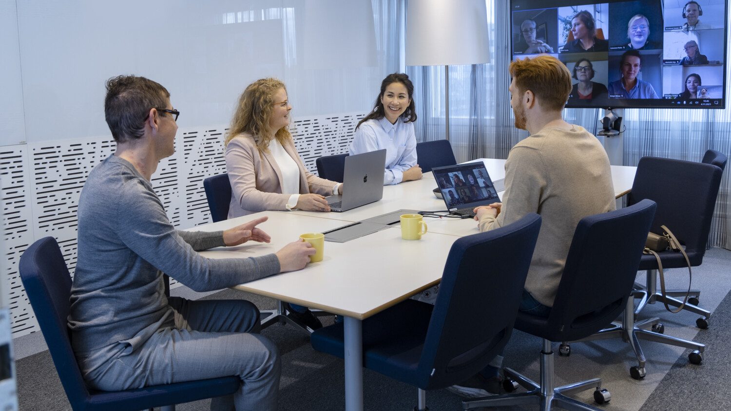 Team from Elisa Finland office sitting in a meeting room.